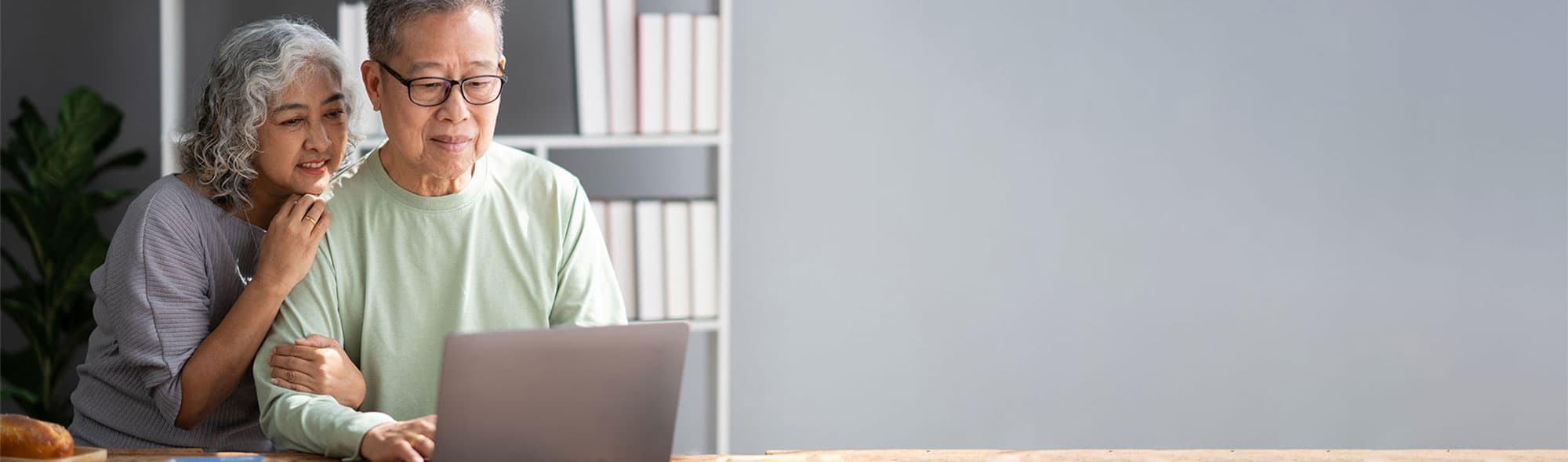 man and woman looking at laptop